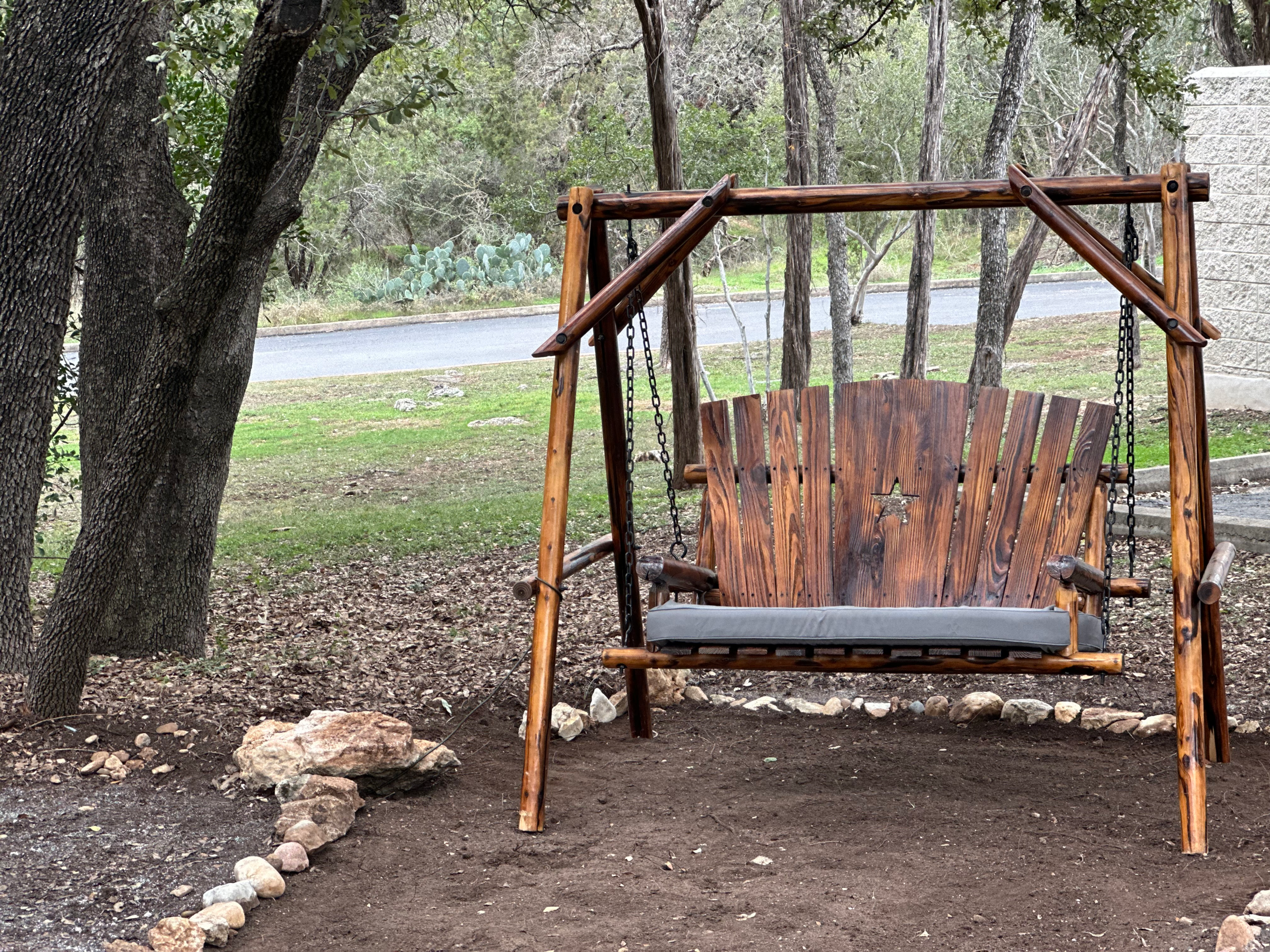 Outdoor reflection space with wooden swing at Austin Ketamine Clinic in Austin Texas providing a peaceful environment for mental health healing and personal reflection.